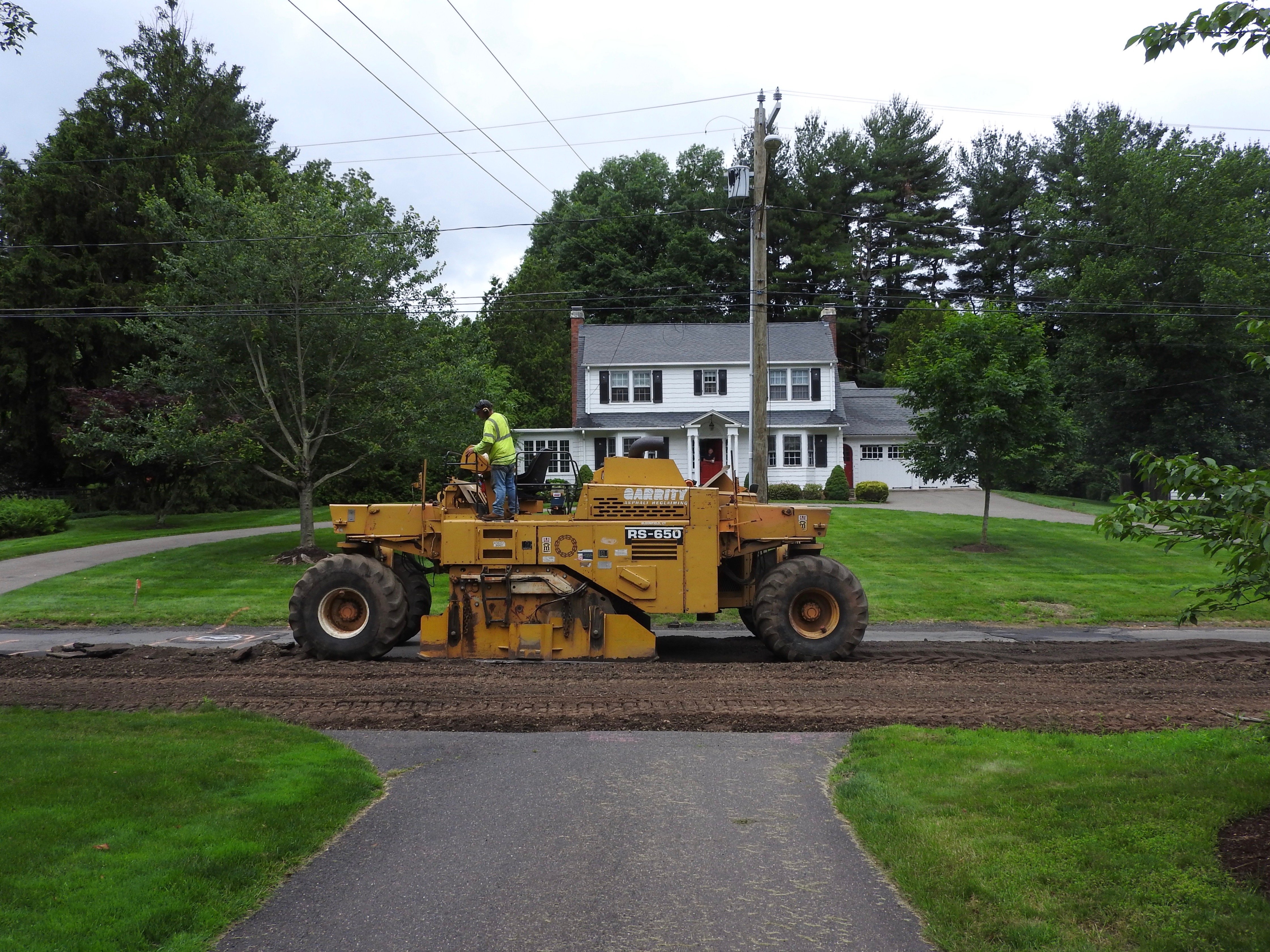 tearing up the street while Bill watches from the  house.